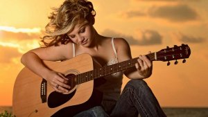 lovely-girl-with-guitar-in-sun-set.jpg